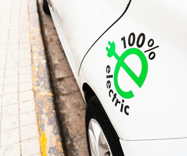 100% electric white car, promotion of sustainable mobility with electric recharging car, design.